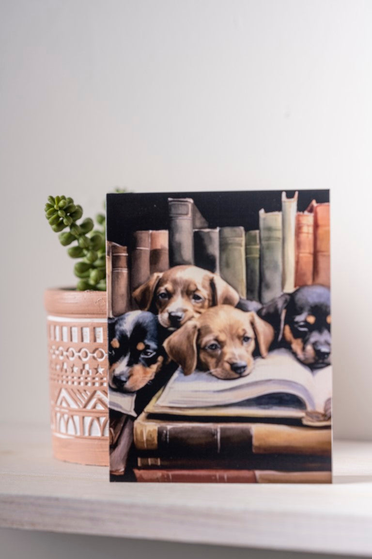Watercolor illustration of four adorable puppies with their heads resting on an open legal book in a law library setting, rendered in soft, warm tones.